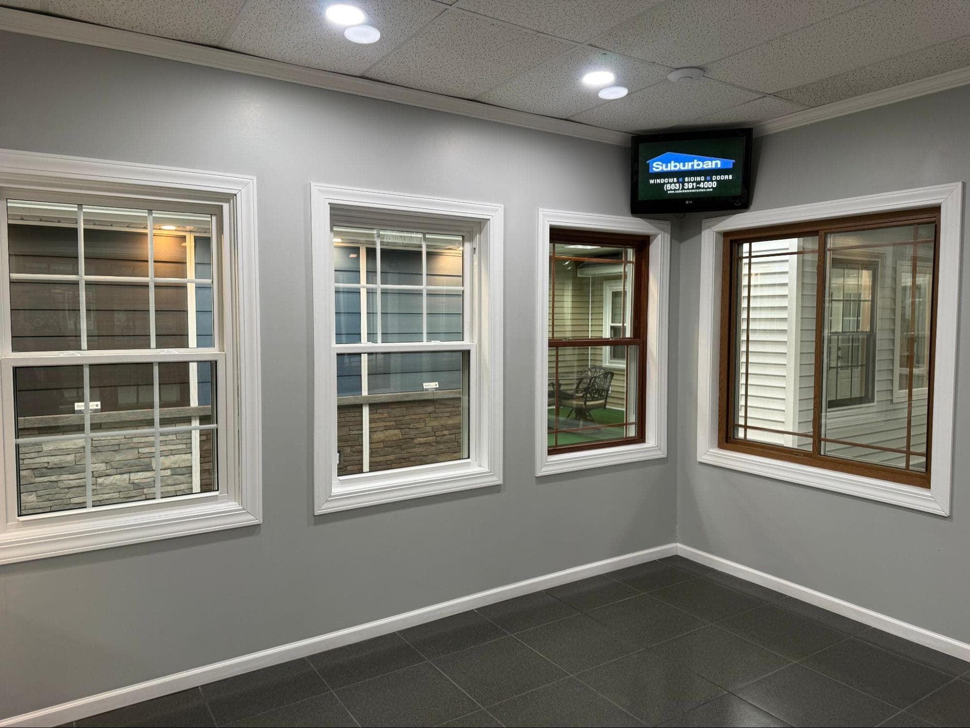 Suburban Construction showroom — full-scale home exterior display